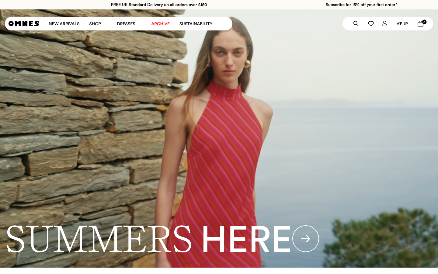 OMNES homepage showing the SUMMERS HERE editorial hero with model in red striped dress against a coastal stone backdrop.